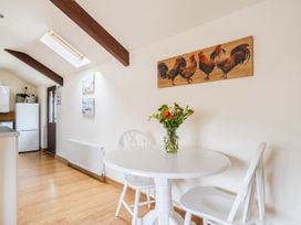 A kitchen with a table and chairs at The Shippon, Breathtaking Views, Private Hot Tub Winkleigh