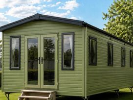 A mobile home with double doors and windows at Billing Aquadrome Holiday Park - 2 Bedroom, Silver