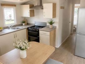 A kitchen with a stove and sink at Billing Aquadrome Holiday Park - 2 Bedroom, Silver, Northampton