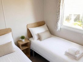 A bedroom with two beds and a window at Billing Aquadrome Holiday Park - 2 Bedroom, Silver in Northampton