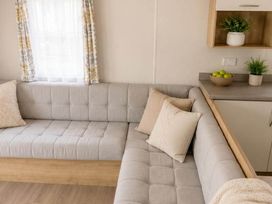 A living room with a couch and a bowl of fruit at Billing Aquadrome Holiday Park - 2 Bedroom, Silver in Northampton