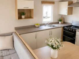 A kitchen with a sink and gas stove at Billing Aquadrome Holiday Park - 2 Bedroom, Silver, Northampton