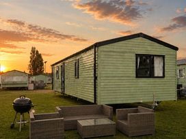 An outdoor area with a trailer home and seating at Billing Aquadrome Holiday Park - 2 Bedroom, Silver, Northampton