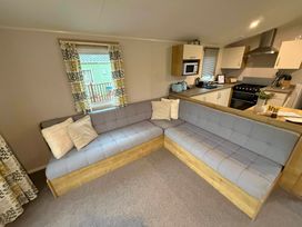 A living room with a corner sofa in Billing Aquadrome Holiday Park - 2 Bedroom, Silver, Northampton