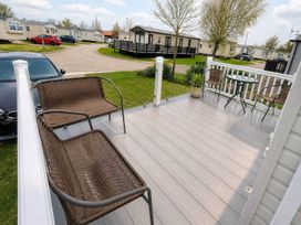 An outdoor area with seating and a table at Tattershall Lakes - Hot Tub - Sleeps 6 - Pets, Tattershall