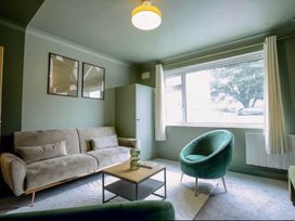 A living room with a sofa and armchair at 2 Bedroom Apartment Sleeps 3 - Garden - Pets in Carbis Bay