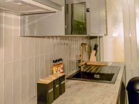 A kitchen with a sink and spice containers at 2 Bedroom Apartment Sleeps 3 - Garden - Pets in Carbis Bay