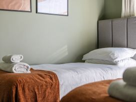 A bedroom with a bed and wall art at 2 Bedroom Apartment Sleeps 3 Garden Pets in Carbis Bay