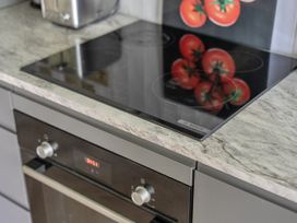 A kitchen with an induction cooktop and oven at 2 Bedroom Apartment Sleeps 3 Garden Pets Carbis Bay