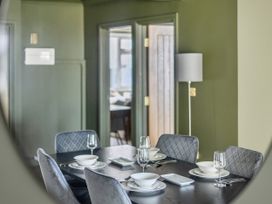 A dining room with a table set for meals at 2 Bedroom Apartment Sleeps 3 Garden Pets in Carbis Bay