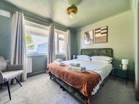 A bedroom with a bed and chair at 2 Bedroom Apartment Sleeps 3 Garden Pets in Carbis Bay
