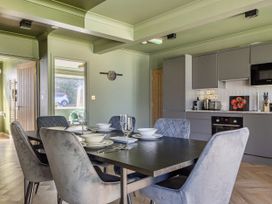 A kitchen with a dining table and chairs at 2 Bedroom Apartment Sleeps 3 Garden Pets in Carbis Bay