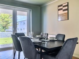 A dining room with a table set for a meal at 2 Bedroom Apartment Sleeps 3 Garden Pets Carbis Bay