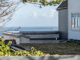 A building and sea view from a rooftop at 2 Bedroom Apartment Sleeps 3 Garden Pets in Carbis Bay