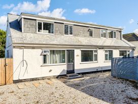 An exterior view of a house with multiple windows and a front door at 2 Bedroom Apartment Sleeps 3 Garden Pets Carbis Bay