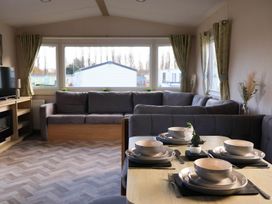 A living room with a dining table and sofa at Static Caravan 3 Bed Sleeps 8 Dog Friendly Parking Northampton