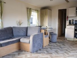 A living room with a sofa and table at Static Caravan 3 Bed Sleeps 8 Dog Friendly Parking Northampton