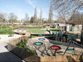 A playground with slides, swings, and benches in an outdoor area