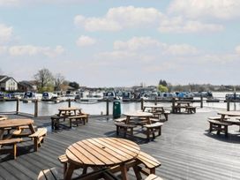 An outdoor area with wooden tables and boats at Static Caravan 3 Bed Sleeps 8 Dog Friendly Parking Northampton