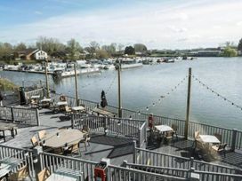 An outdoor seating area overlooking water and boats at Static Caravan 3 Bed Sleeps 8 Dog Friendly Parking Northampton