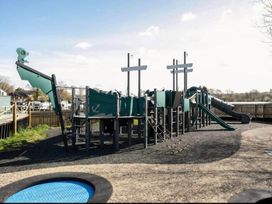 A playground with a climbing structure and slide