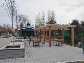 An outdoor dining area with tables and chairs at Static Caravan 3 Bed Sleeps 8 Dog Friendly Parking Northampton