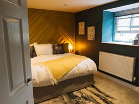 A bedroom with a bed and wall art at Snowdon Studio Apartment in Tal-y-cafn near Llandudno Junction