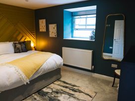 A bedroom with a bed and window at Snowdon Studio Apartment Tal-y-cafn near Llandudno Junction