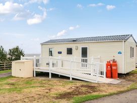 A cabin with a ramp and gas cylinders at Cabin - Sleeps 4 - Pets Ok - Balcony - Parking, Haven Park, Doniford Bay near Watchet