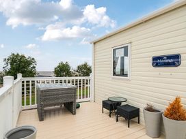 An outdoor area with a deck and hot tub at Cabin - Sleeps 4 - Pets Ok - Balcony - Parking, Haven Park, Doniford Bay near Watchet