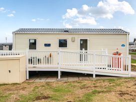 An outdoor view of a cabin with a ramp at Cabin - Sleeps 4 - Pets Ok - Balcony - Parking, Haven Park, Doniford Bay near Watchet