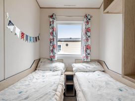 A bedroom with two beds and a window at Cabin - Sleeps 4 - Pets Ok - Balcony - Parking, Haven Park, Doniford Bay near Watchet