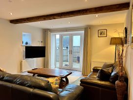 A living room with a television and sofa at Cottage Sleeps 6 Garden Parking near Beaulieu Farm near Coleford