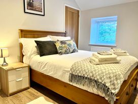 A bedroom with a bed and bedside table at Cottage Sleeps 6 Garden Parking Beaulieu Farm near Coleford