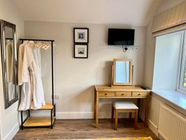 A dressing room with a mirror and vanity table at Cottage Sleeps 6 Garden Parking Beaulieu Farm near Coleford
