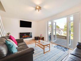 A living room with a sofa, coffee table, and television at Ty Gwyn Borth-y-gest House Sleeps 5 Garden Parking Borth-Y-Gest
