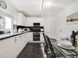 A kitchen with a table set for dining at Ty Gwyn Borth-y-gest House Sleeps 5 Garden Parking in Borth-Y-Gest