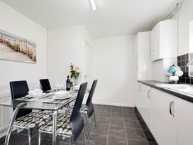 A kitchen with a dining table and chairs at Ty Gwyn Borth-y-gest House Sleeps 5 Garden Parking Borth-Y-Gest