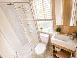 A bathroom with a shower, toilet, and sink at Cala Gran 3Bed Caravan Sleeps 8 Wrap Decking Fleetwood