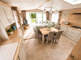 A living room with a dining table and chairs at Cala Gran 3Bed Caravan Sleeps 8 Wrap Decking Fleetwood