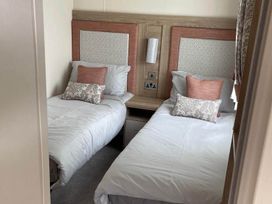 A bedroom with twin beds and a bedside table