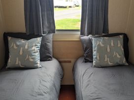 A bedroom with two beds and decorative pillows at 