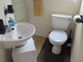A bathroom with a sink and toilet at 