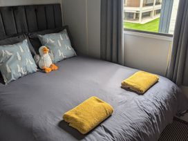 A bedroom with a bed and decorative pillows at 