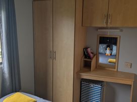 A bedroom with a wardrobe and desk at 