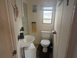 A bathroom with a sink and toilet at a property in Anderby Creek