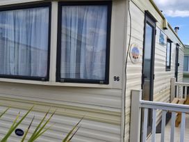Exterior view of a caravan with windows and door at the caravan park in Anderby Creek
