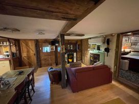 A living room with a sofa and table at The Old Barn in Bovey Tracey