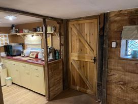 A kitchen with cabinets and appliances at the property in Bovey Tracey