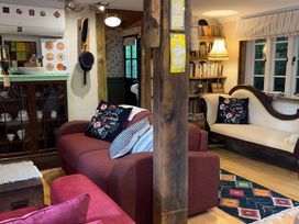 A living room with sofas and a bookshelf at  in Bovey Tracey